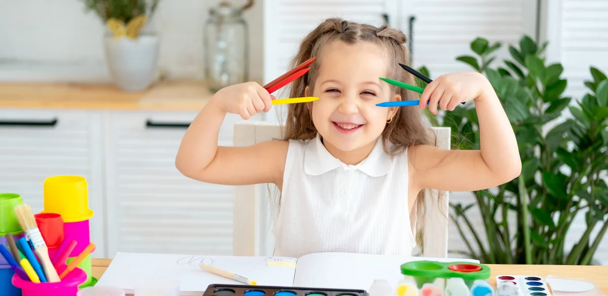 Little girl playing with colors